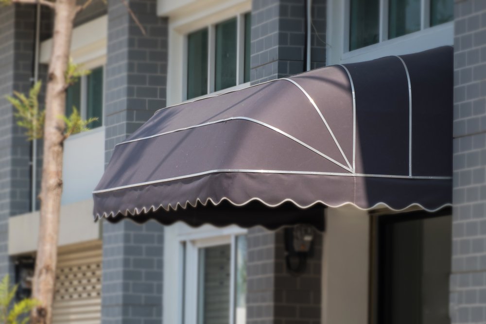 Awning,Mounted,On,The,Front,Door,Of,The,Shop.